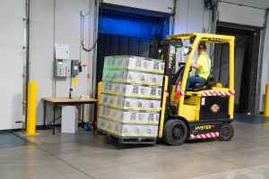 man riding on yellow forklift